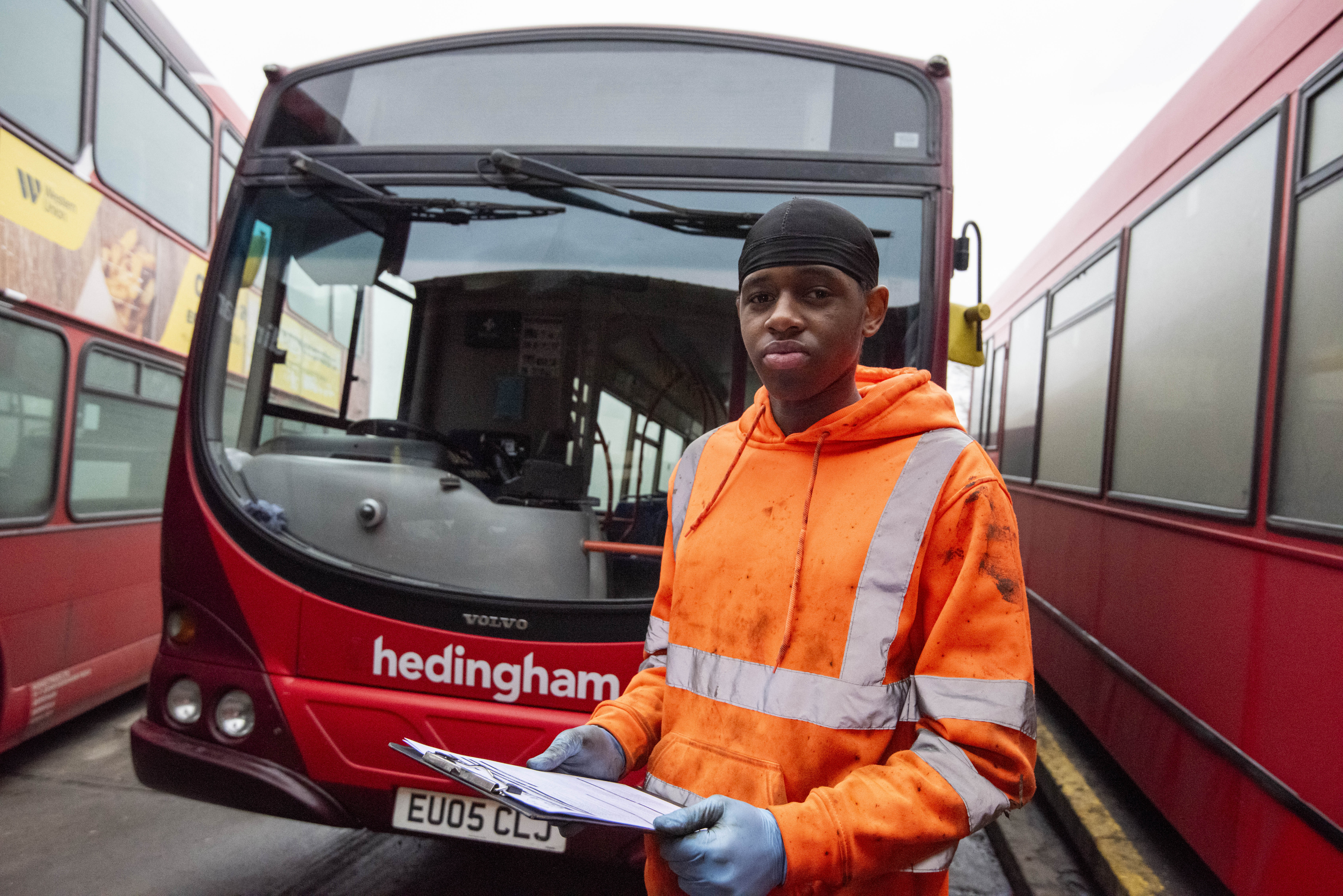LeVaughn in front of a Hedingham and Chambers Bus