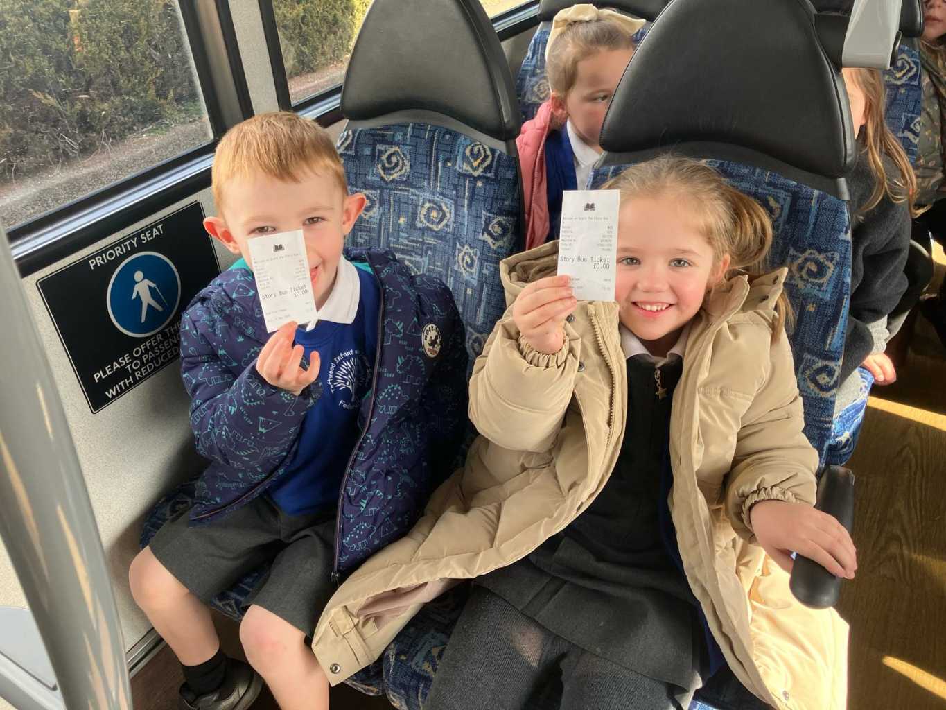 Children with their Story Bus tickets
