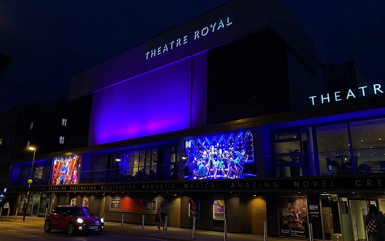 Theatre Royal Norwich, lit up in blue light at night